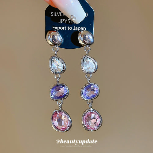 Pink and Purple Crystal Linear Drop Earrings shown in a styled close-up