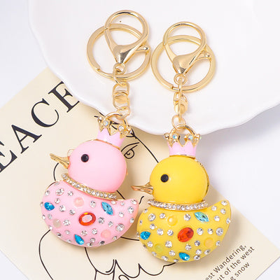 Pink and yellow crowned duck rhinestone keychains side by side