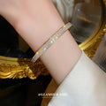 Gold Tone Hinged Bangle With Triple Rows Of Clear Crystals view 2