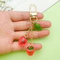 Strawberry Charm Keychains Featuring Magenta Strawberry Across 15 Pictured Variations view 2
