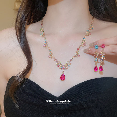 Multicolor crystal bow flower necklace and drop earrings worn together