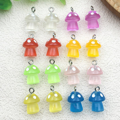 Colorful mushroom charms arranged on a light background