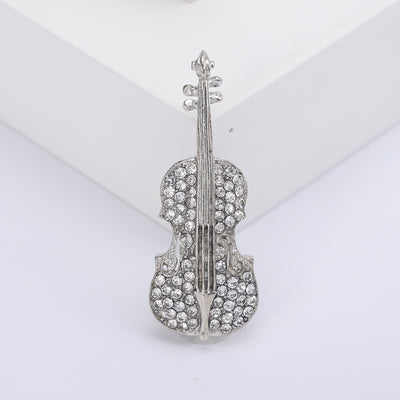 Front product view of the crystal violin brooch on a light background