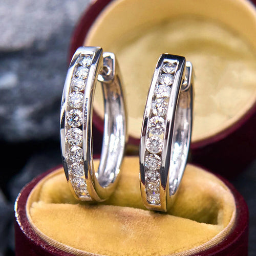 Angled silver CZ channel set huggie hoop earrings in box
