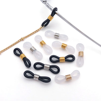 Clear assorted shape jewelry findings arranged on a light background
