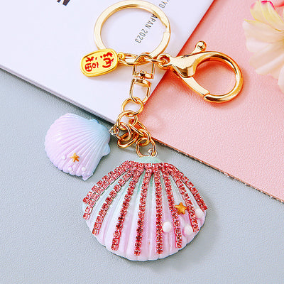 Main image 1 shows a supplied presentation of jeweled fortune shell keychains with visible attached key hardware.