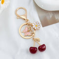 Cherry Charm Keychain with Enamel Butterfly and Daisy Flower Pendant view 2