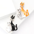 Two Cat Enamel Brooch with Polished Metal and Decorative Accents view 1