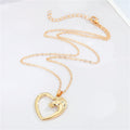 Gold Tone Open Heart and Horse Head Pendant Necklace with Curved Frame view 1