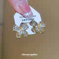 Gold Tone Bow Stud Earrings with Clear Stones and Pearl Centers view 2