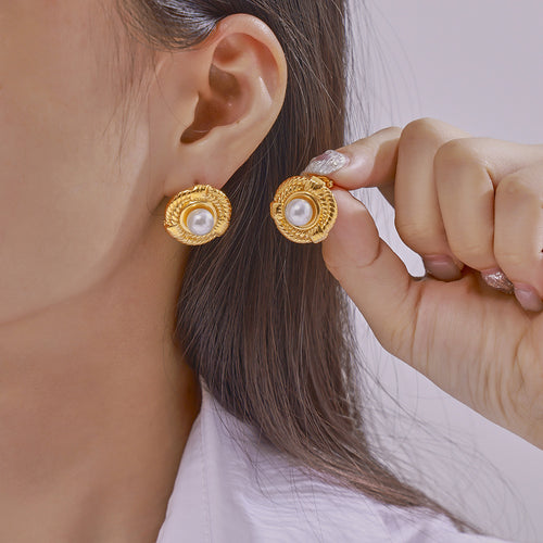 Model putting on gold twisted rope pearl circle earring