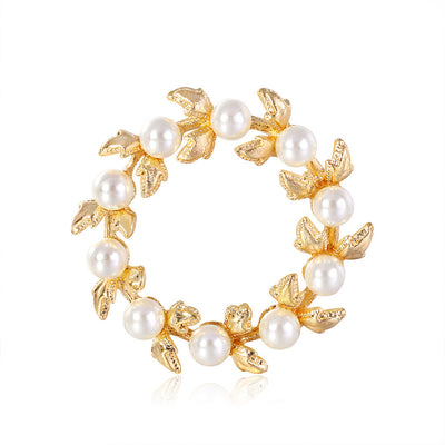 Front product view of the floral wreath brooch pin in gold