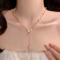 Gold Tone Leaf and Pearl Drop Y Necklace with Delicate Chain view 1