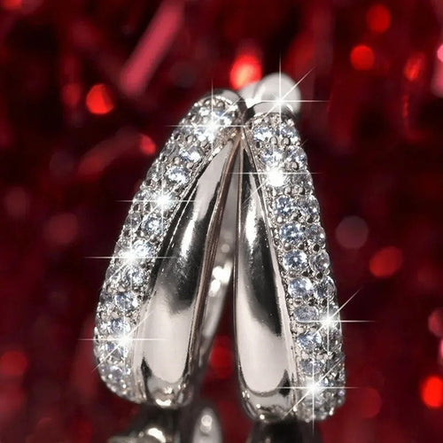 Crystal Pave Curved Huggie Hoop Earrings Polished Statement Fashion Jewelry shown in a styled view