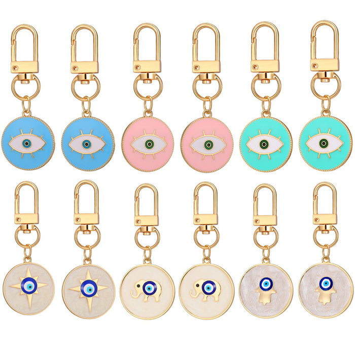 Twelve Piece Gold Tone Round Elephant and Evil Eye Clip Keychain Set