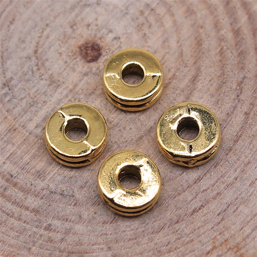 Styled close-up of the double groove flat spacer bead showing flat round profile with twin edge grooves