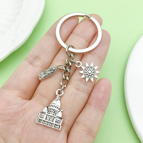 Image 2 showing a hand holding a silver keychain.