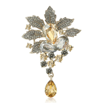 Champagne crystal leaf brooch with teardrop pendant on white
