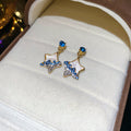Blue Star Dangle Earrings with Gold Tone Open Star Frames view 6