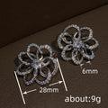 Silver-Tone Open Flower Stud Earrings with Clear Stone Details view 4