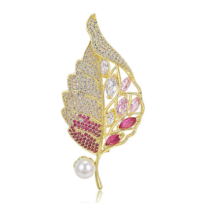 Front product view of the openwork gold tone leaf brooch on a light background
