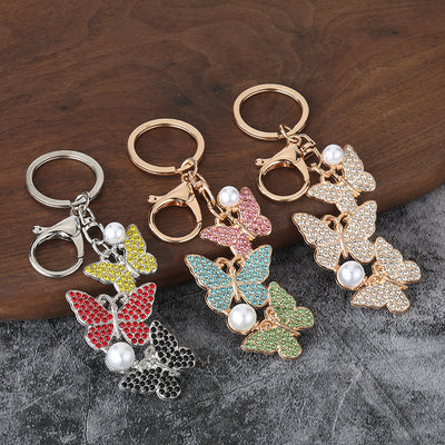 Group of triple butterfly keychains in multiple stone colors