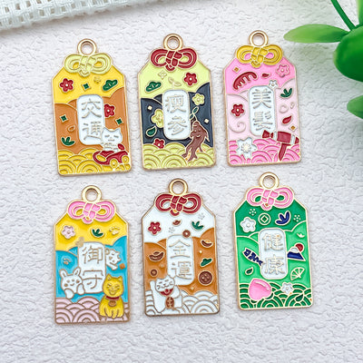 Gold-tone assorted shape charms arranged on a light background