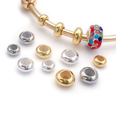Donut shaped metal stopper beads with silicone cores arranged as a full product overview