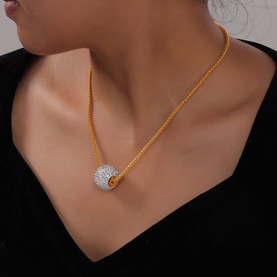 Model wearing gold wheat chain with clear pave sphere pendant