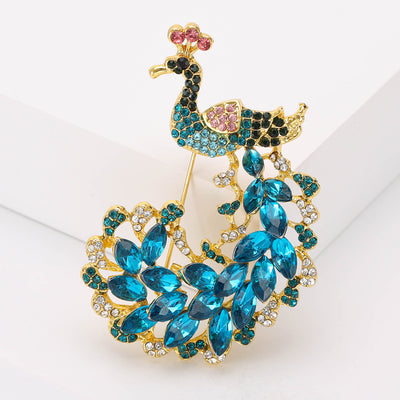 Front product view of the blue crystal peacock brooch on a light background