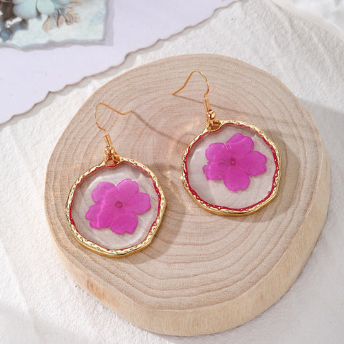 Magenta pressed flower gold rim irregular disc earrings on wood slice
