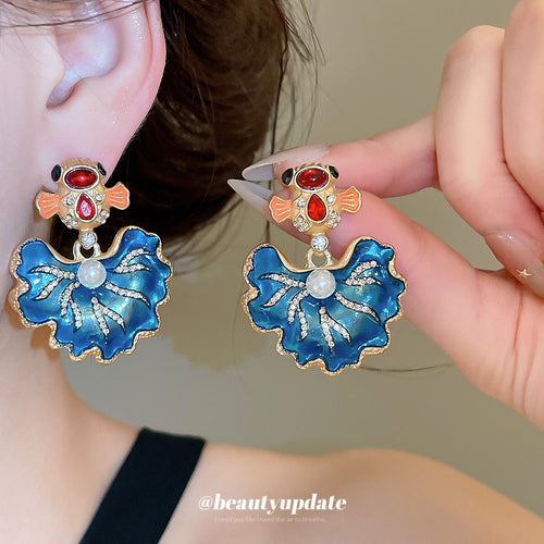 Blue Enamel Koi and Flower Statement Stud Earrings shown in a display view