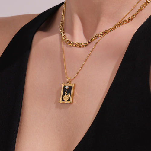 Model wearing gold double layer curb and snake chain enamel pendant necklace