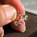 Gold Tone Huggie Earrings with Crystal Bow Drops with Clear Crystal Details view 3