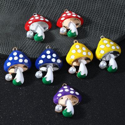 Seven enamel mushroom charms in red, blue, yellow and purple with white-spotted caps and pearl accents