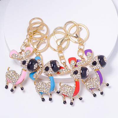 Four rhinestone donkey keychains in pink blue red and purple on white stand