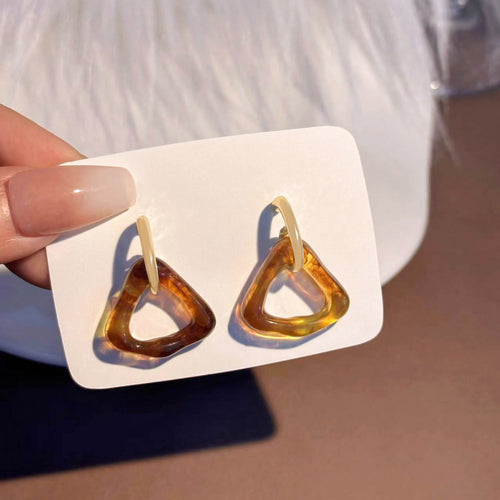 Caramel tortoiseshell triangle resin hoops held on white card