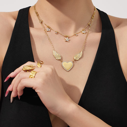 Display view of wing heart ring and necklaces in main image 2.