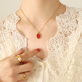 Red Oval Pendant Necklace Gold and Steel Frame Chain view 4