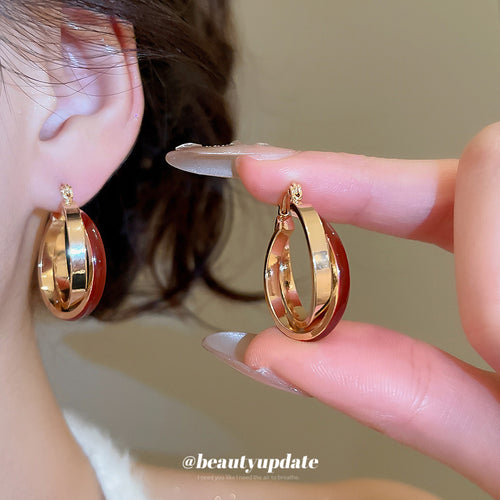 Close view of the colors and surface details on red and white double hoop earrings