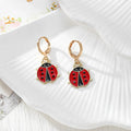 Gold Tone Red Ladybug Huggie Earrings in Six Designs view 2