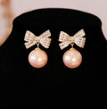 Gold Tone Bow and Pearl Drop Stud Earrings in Two Colors view 6