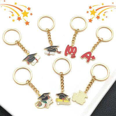 Front display of graduation keychains and red exam message phone straps with visible colors and attached hardware