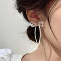 White Bow Pearl Chain Drop Earrings with Polished Metal Accents view 2