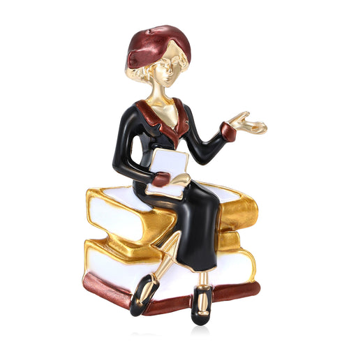 Angled display of seated teacher figure on a stack of books with one hand raised