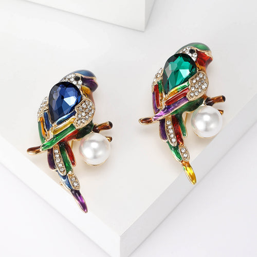 Front view of colorful bird brooch with crystal body and pearl dangle
