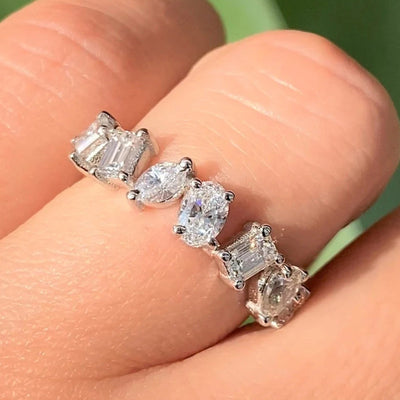 Silver mixed-cut clear CZ row ring worn on fingers close-up