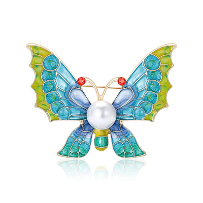 Blue enamel butterfly brooch with pearl body and red crystal antennae
