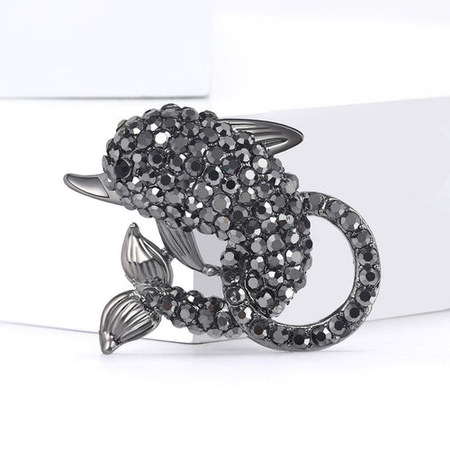 Black gunmetal rhinestone dolphin brooch on white blocks