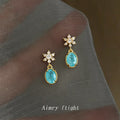 Gold Tone Clear Stone Snowflake And Aqua Oval Stud Earrings view 1